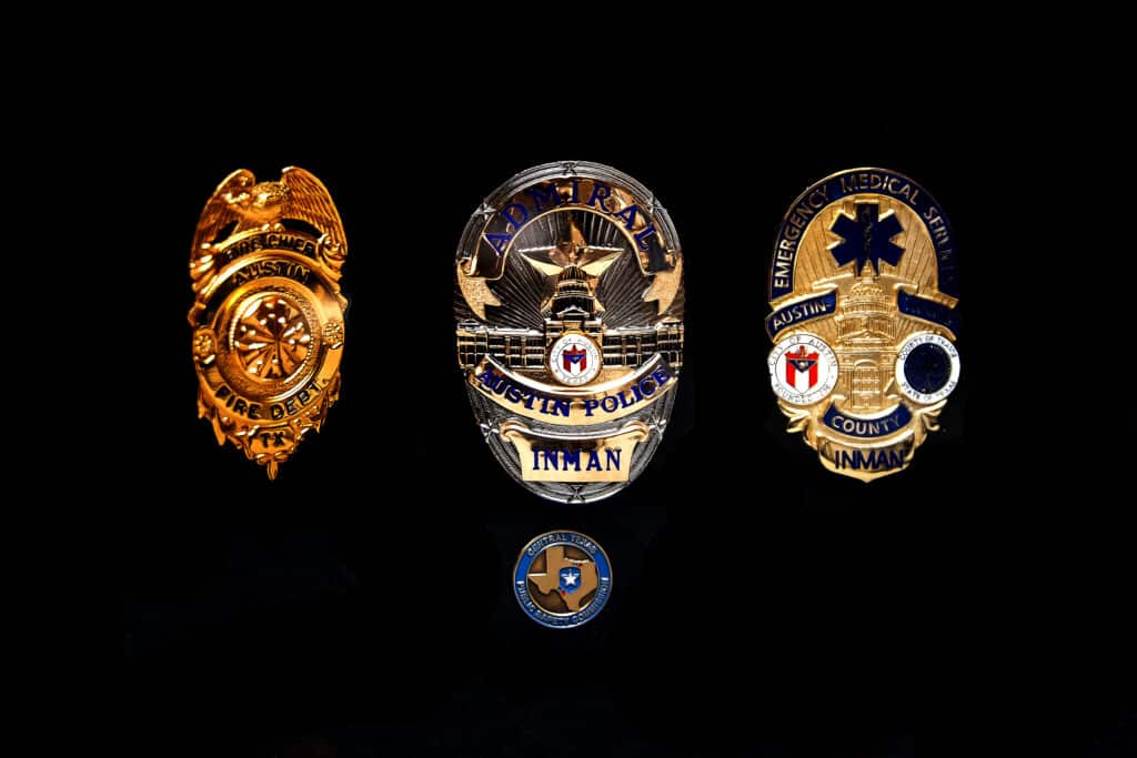 Austin Police, Fire, EMS badges on display.
