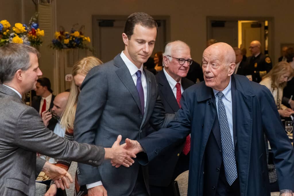 Group of people shaking hands at event