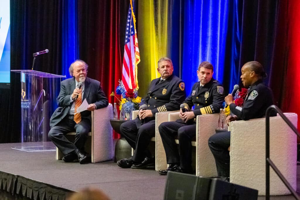 Panel discussion with police officers and moderator on stage.
