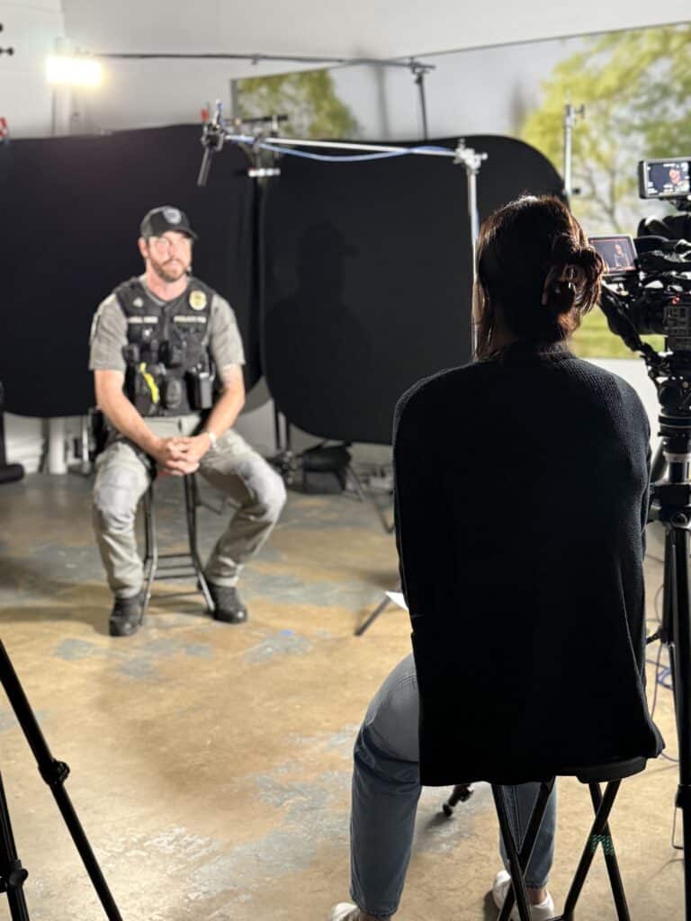 Police officer interviewed on camera in studio