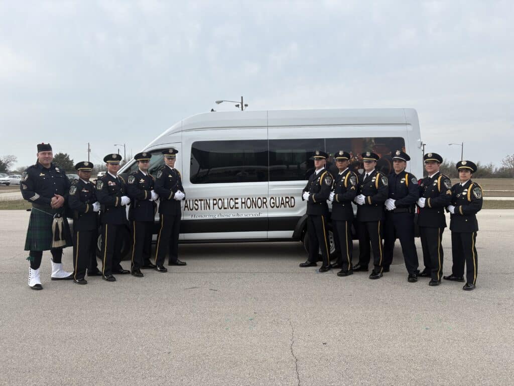 Austin Police Honor Guard standing beside white van