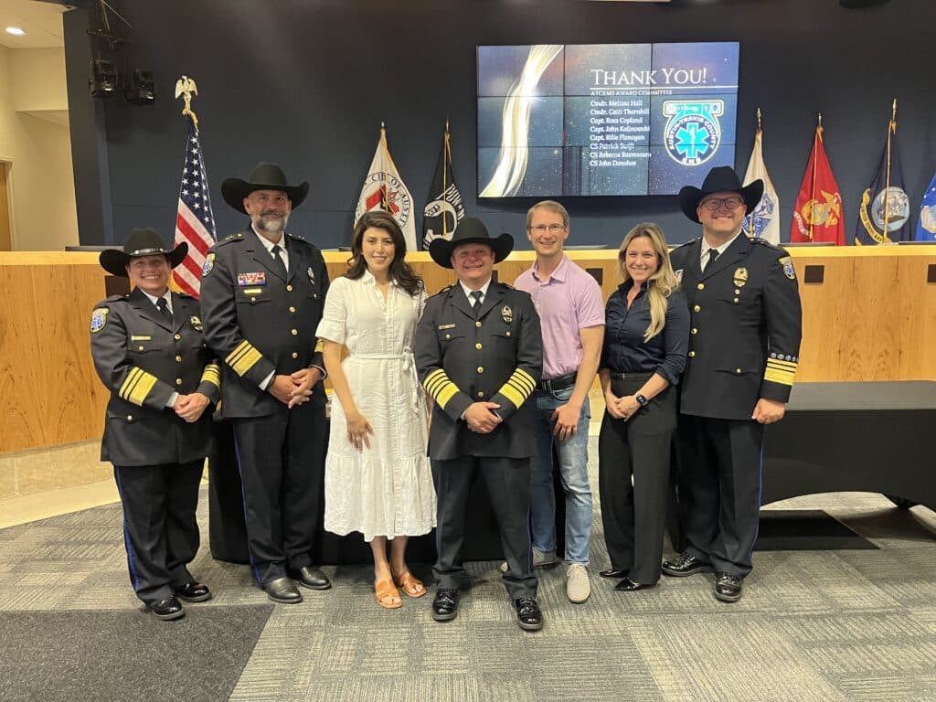 Uniformed officers and civilians at award ceremony indoors