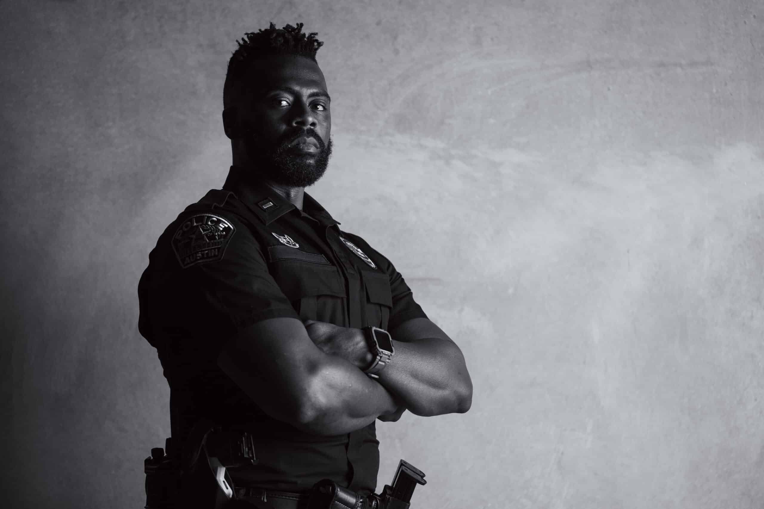 Police officer in uniform with arms crossed